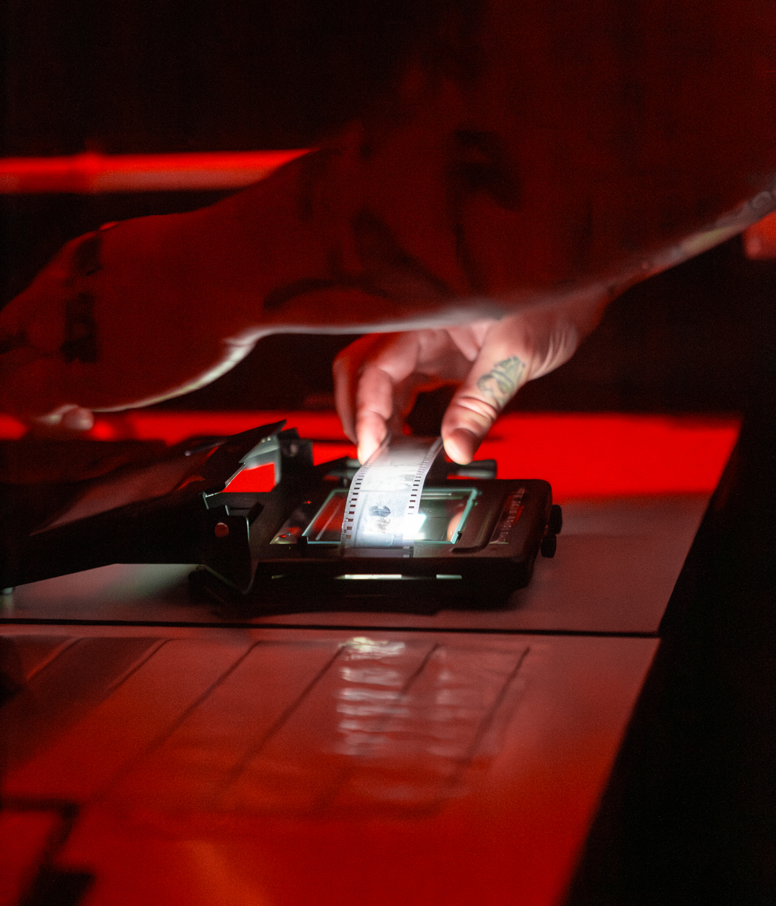 Hands loading a negative carrier